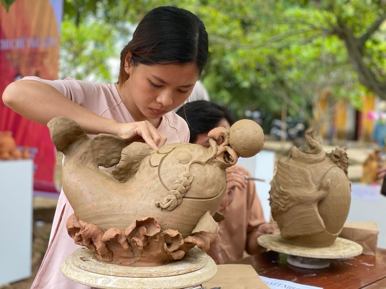 Artisan shaping pottery at Thanh Ha Pottery Village in Hoi An