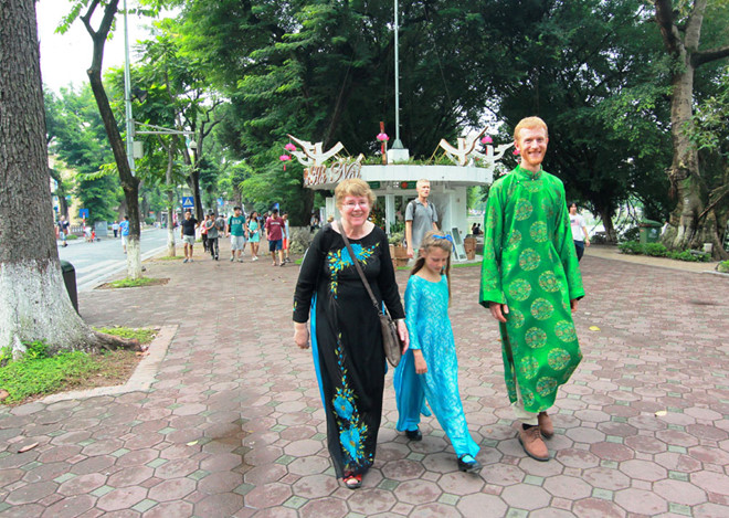Tourist trying on Ao Dai